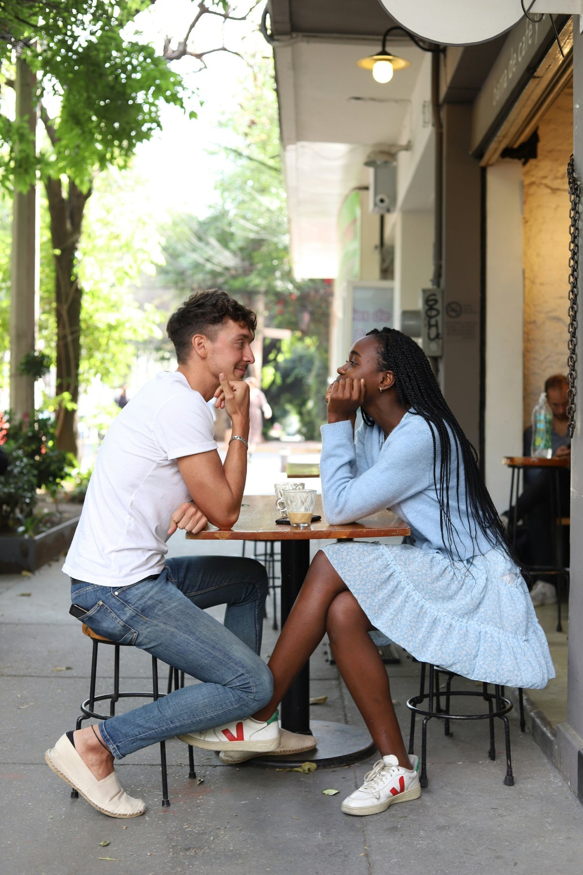 Couple talking on a date at an outdoor cafe for Flare Events matchmaking